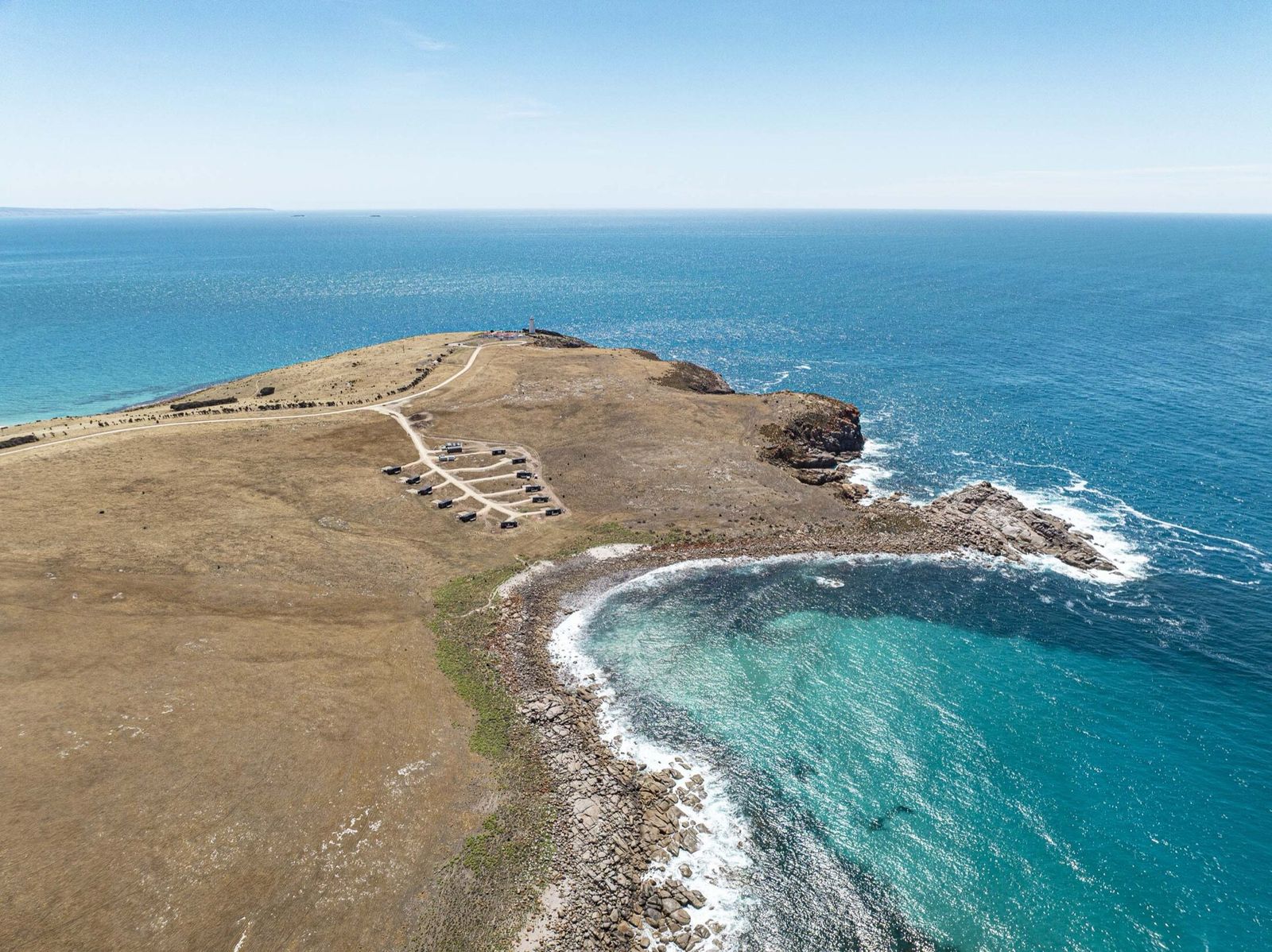 Aerial view of the Kangaroo Island retreats along a headland above turquoise water