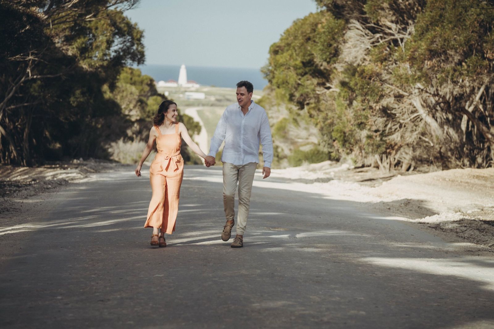 Two guests walking a quiet road on Kangaroo Island towards the Cape Willoughby lighthouse