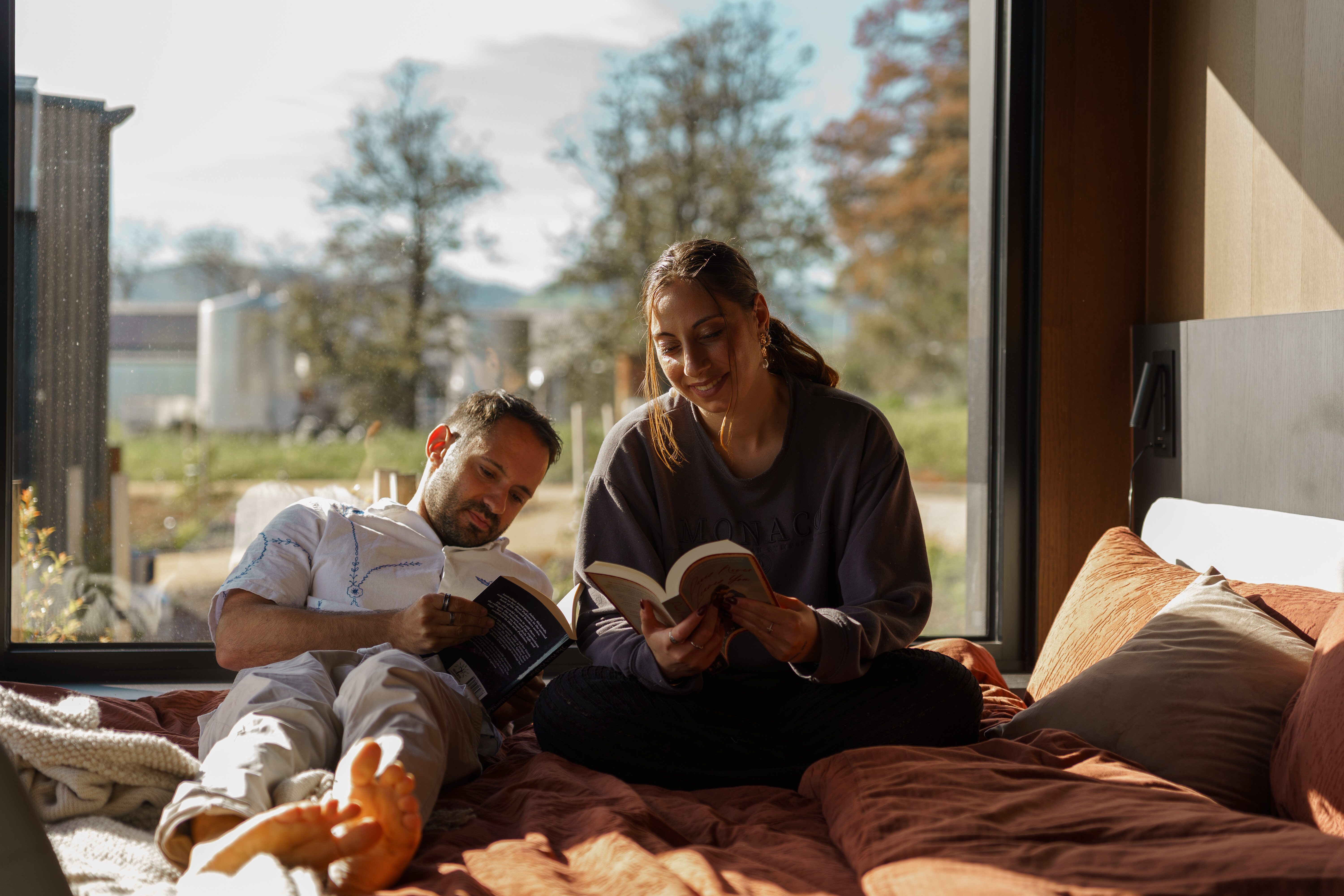 Guests reading by the window of an AUTRA cabin