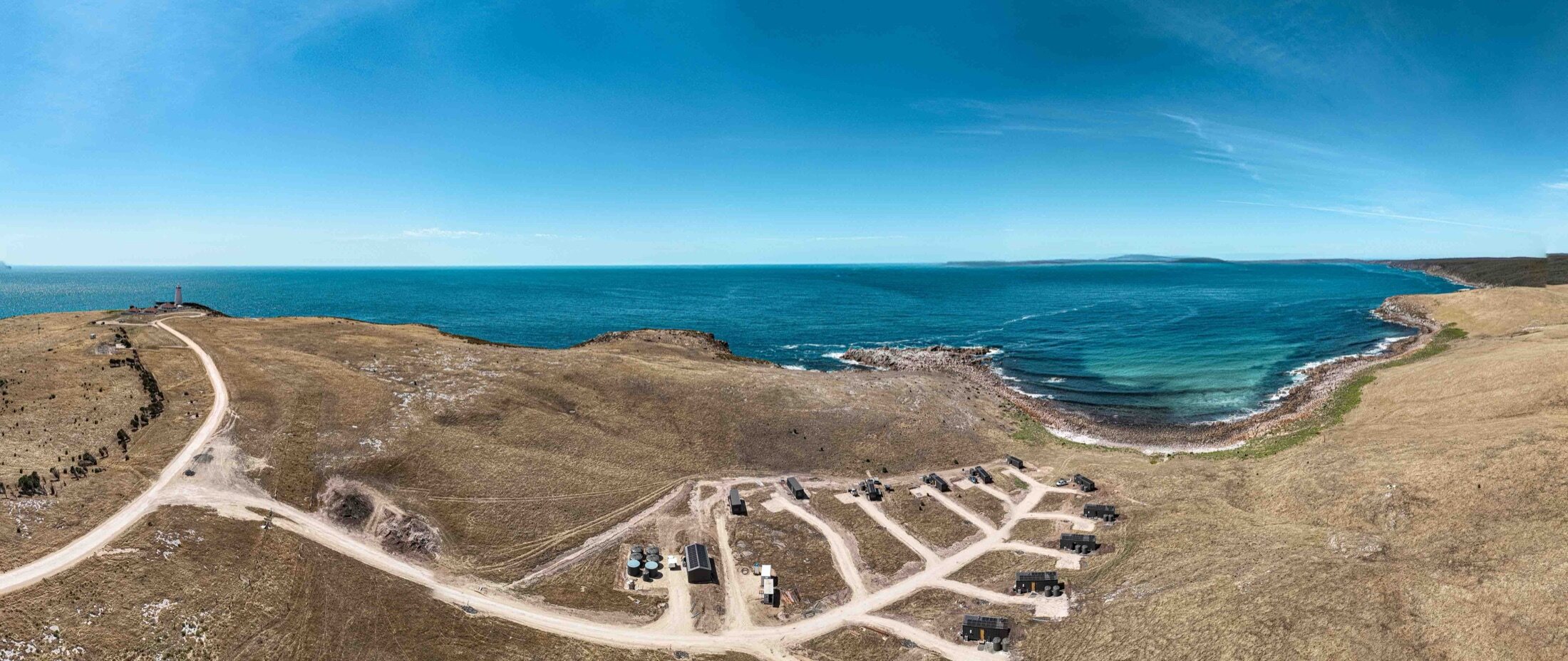The twelve AUTRA retreats laid out along the Cape Willoughby headland, the Southern Ocean beyond